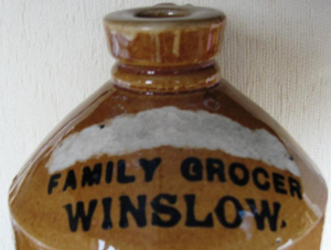 Stoneware flagon marked Family Grocer Winslow