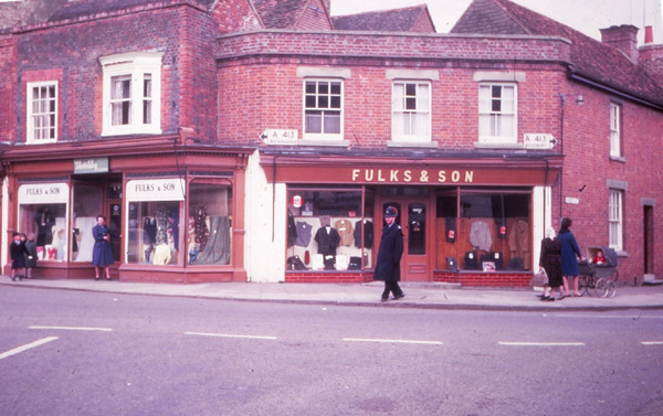 Colour photo of Fulks's with a policeman walking past