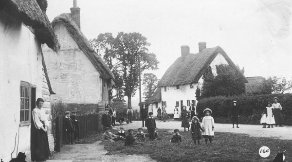 Cottages in Shipton, children playing around the road